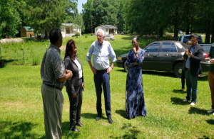 People gathered in a field, chatting.