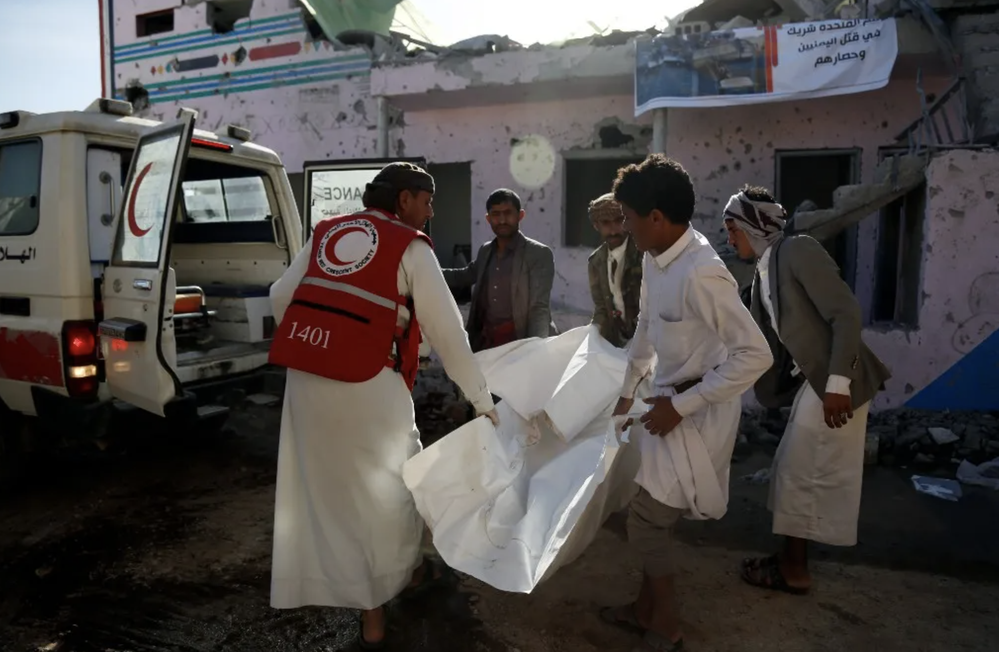 Rescue workers carry the body of a victim killed by aerial attacks carried out by aircraft of the coalition led by Saudi Arabia targeting a prison in the Houthi stronghold Saadah Province, on January 22, 2022 in Saadah, Yemen. The assault reportedly killed at least 90 prisoners and injured more than 100 others. (Photo by Mohammed Hamoud/Getty Images)